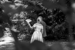 Photographe mariage : Gros plan en noir et blanc des mariés dessinant un cœur sur le sable
