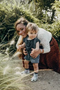 Maman qui aide son fils a faire ses premiers pas dans leur jardin exotique